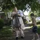 Brittany Cunningham 31, walks down the street with her nephew and his dog in Nelsonville, Ohio. Image by Wong Maye-E/AP Photo. United States, 2020.