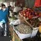 Axayacatl Figueroa, who recovered after suffering from COVID-19, walks by a neighborhood food stand in Brooklyn, New York, Monday, July 6, 2020. Image by Mark Lennihan/AP Photo. United States, 2020.