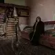 In this Feb. 12, 2018, photo, an elderly woman smokes a water pipe at the home of Ahmed al-Kawkabani, leader of the southern resistance unit in Hodeida, in al-Khoukha, Yemen. Image by Nariman El-Mofty. Yemen, 2018. </p>
<p>